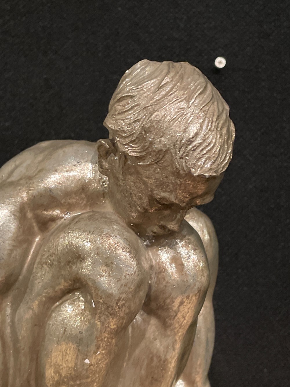 An Art Deco silvered figure of a crouching male nude View IX