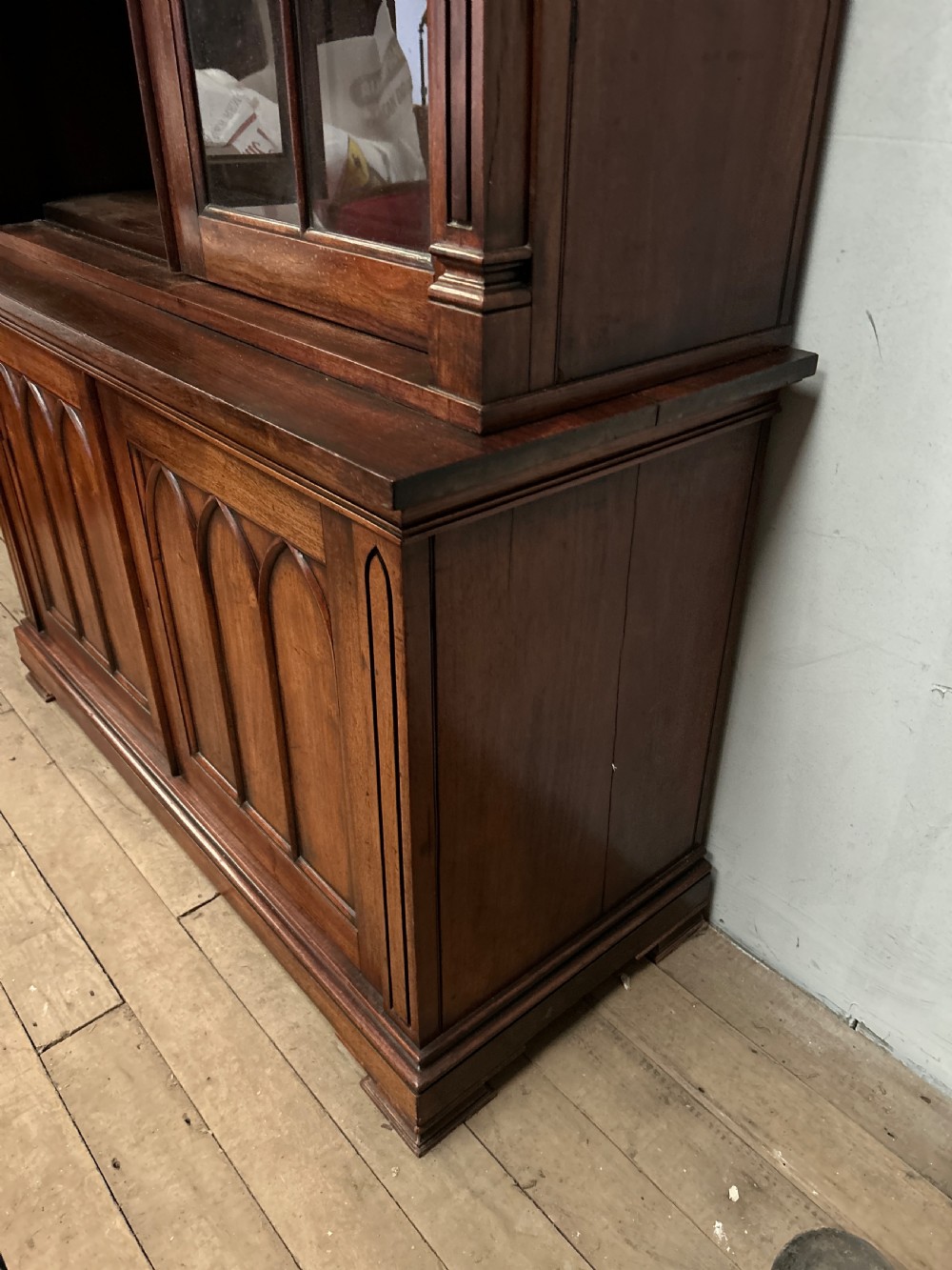 A dark George IV rosewood two-tier bookcase featuring upper glazed doors with Gothic lancet arches and lower panelled doors with tracery. View II