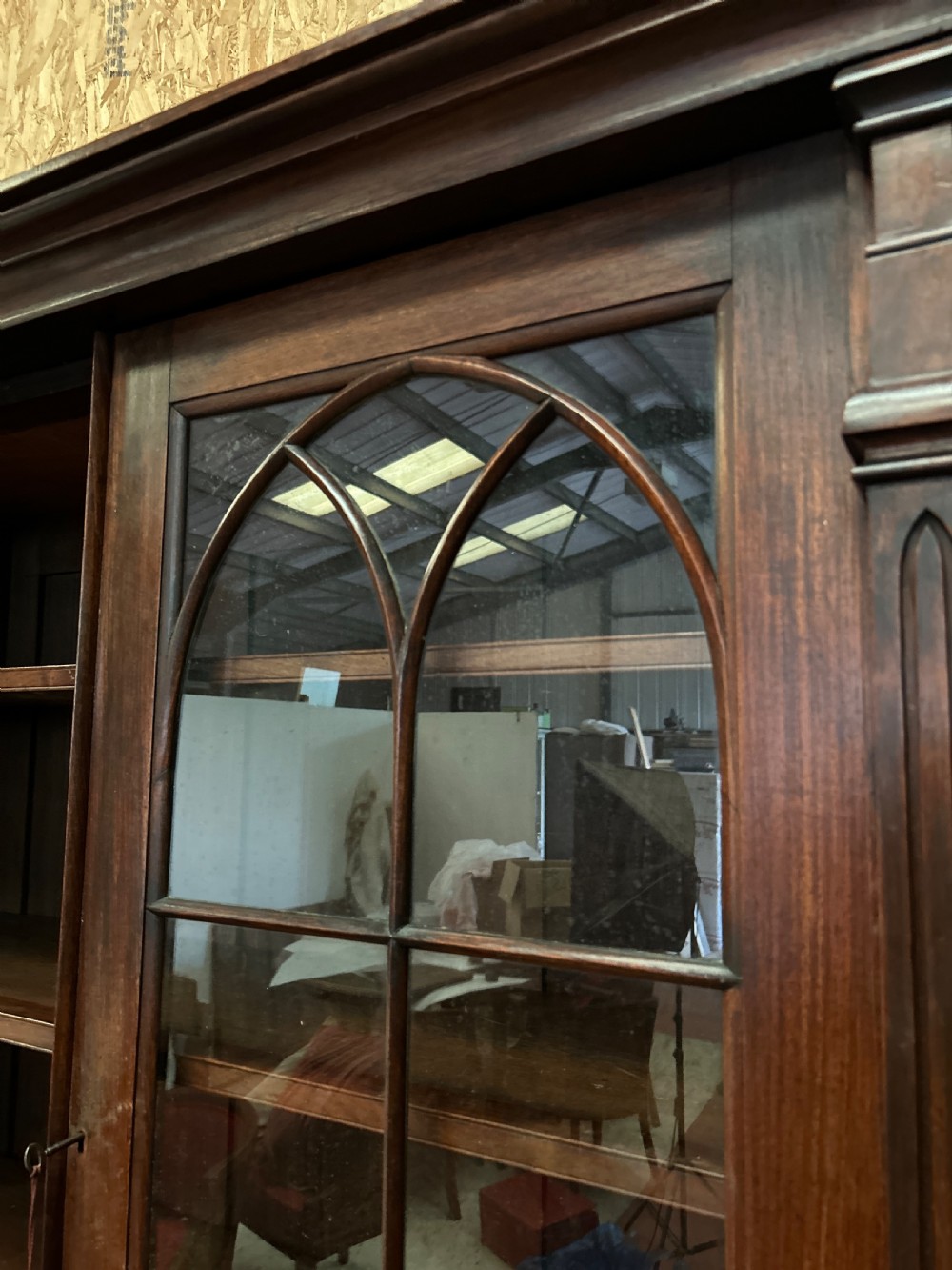 A dark George IV rosewood two-tier bookcase featuring upper glazed doors with Gothic lancet arches and lower panelled doors with tracery. View III