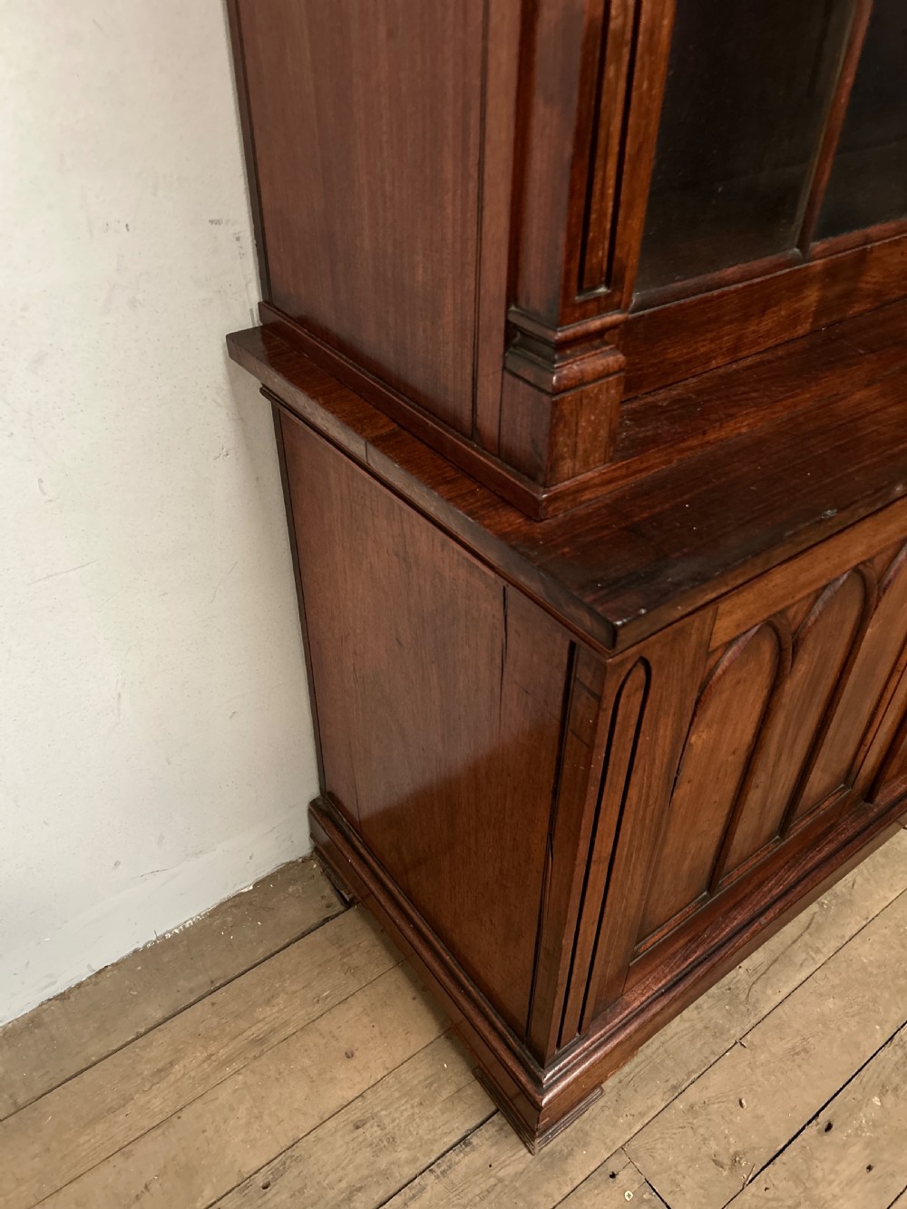 A dark George IV rosewood two-tier bookcase featuring upper glazed doors with Gothic lancet arches and lower panelled doors with tracery. View V