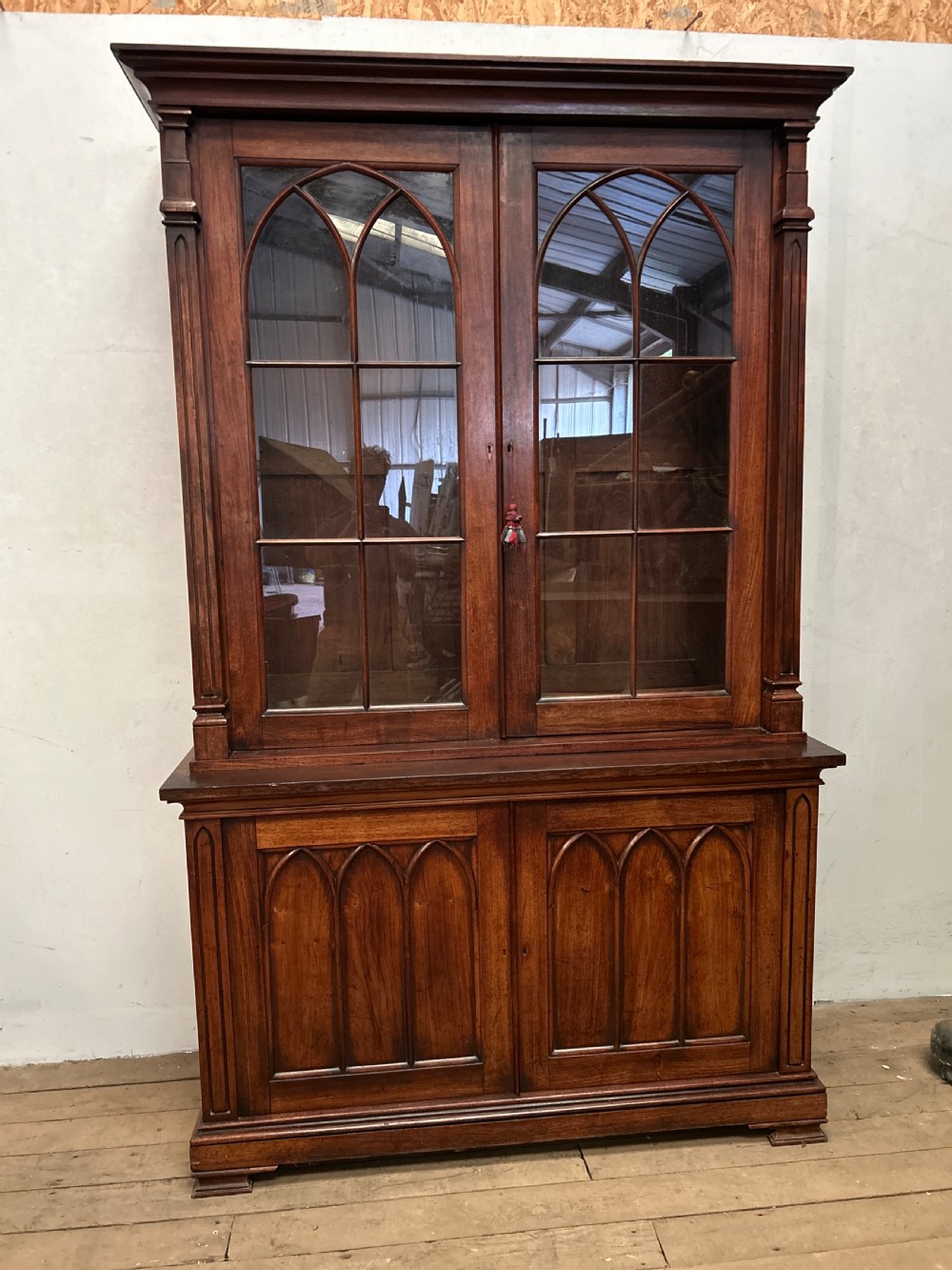 A dark George IV rosewood two-tier bookcase featuring upper glazed doors with Gothic lancet arches and lower panelled doors with tracery. View X