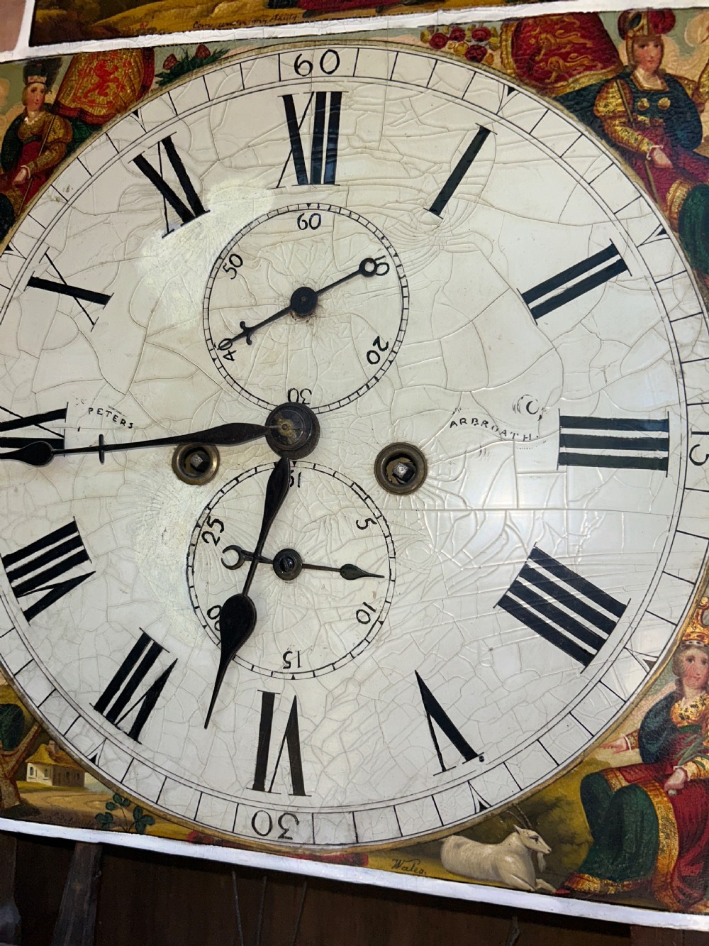 An upright wooden longcase clock featuring a carved swan-neck pediment, a painted dial face, spiral barley twist columns, and a rectangular trunk door. View IV