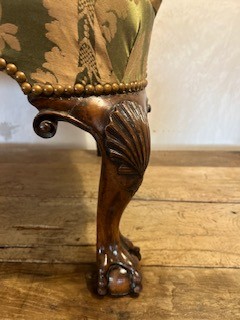An antique George II wing armchair upholstered in patterned green damask fabric with carved walnut cabriole legs. View VI