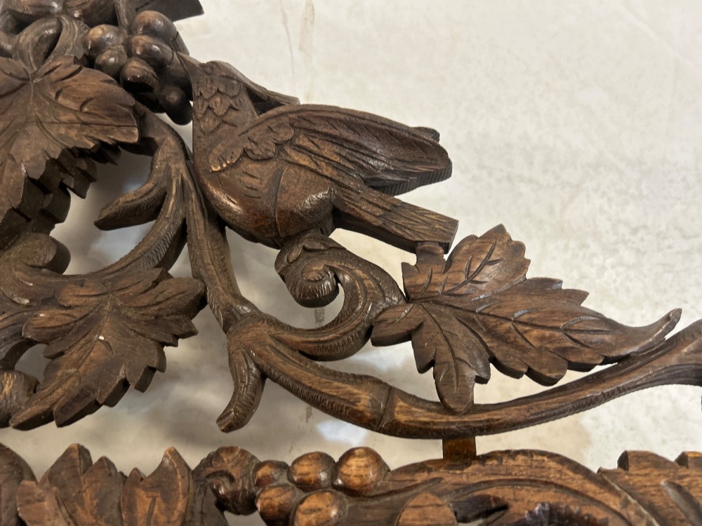 An ornate French oak wall mirror featuring intricate hand-carved leaf and grapevine motifs around a rectangular glass plate. View III