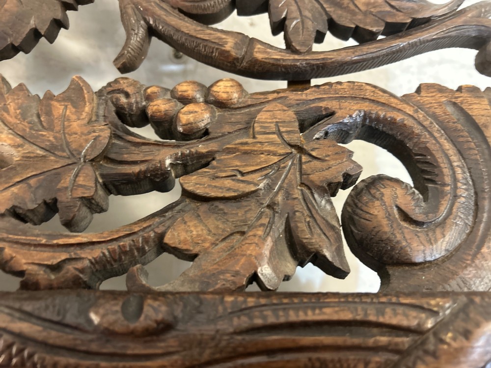 An ornate French oak wall mirror featuring intricate hand-carved leaf and grapevine motifs around a rectangular glass plate. View IV