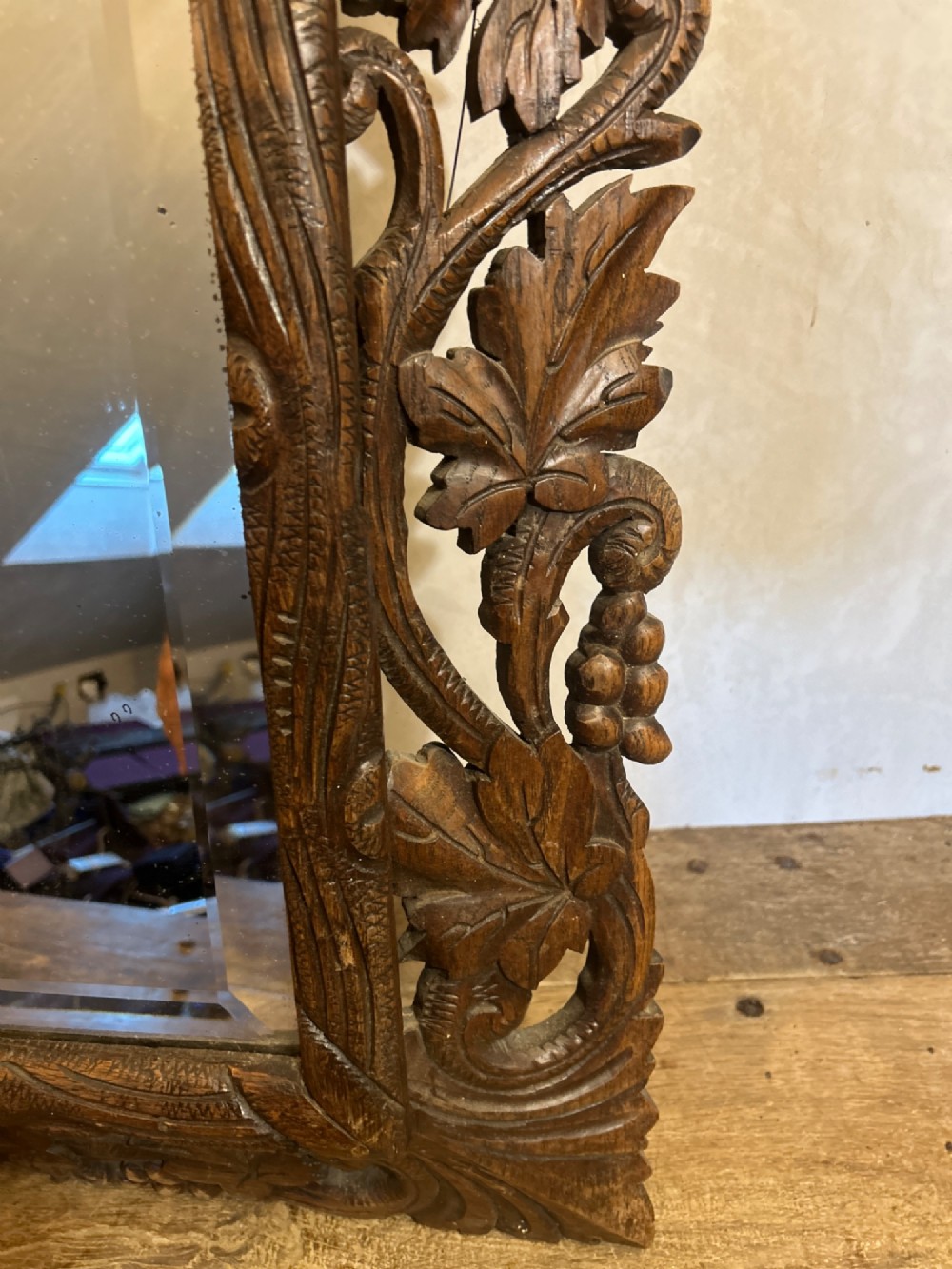 An ornate French oak wall mirror featuring intricate hand-carved leaf and grapevine motifs around a rectangular glass plate. View X