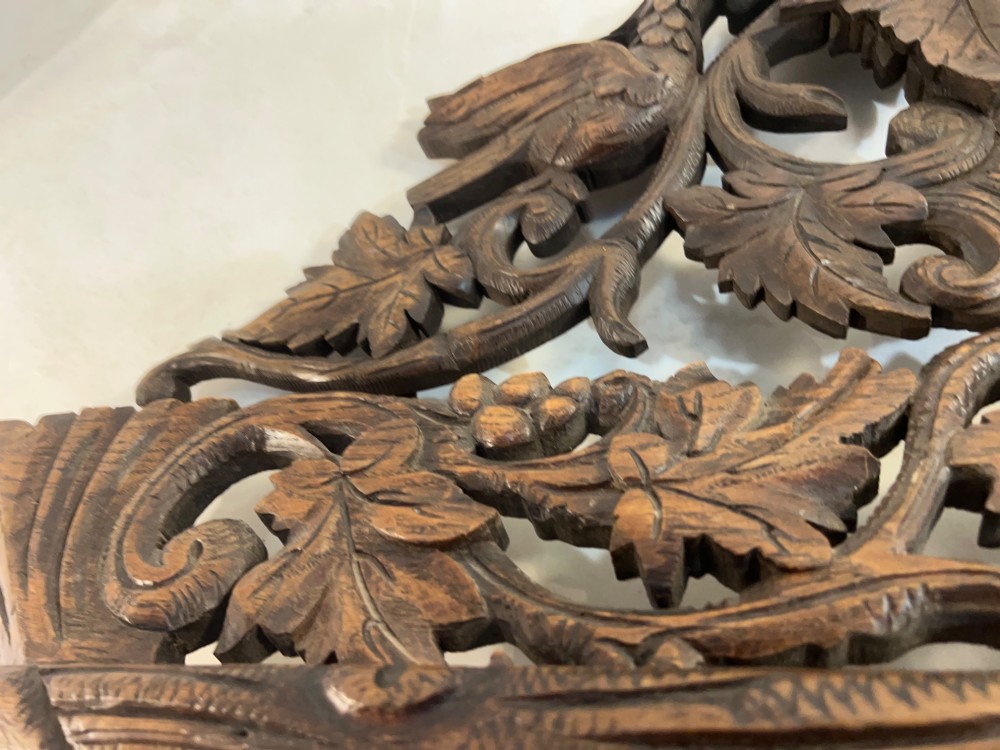 An ornate French oak wall mirror featuring intricate hand-carved leaf and grapevine motifs around a rectangular glass plate. View XI