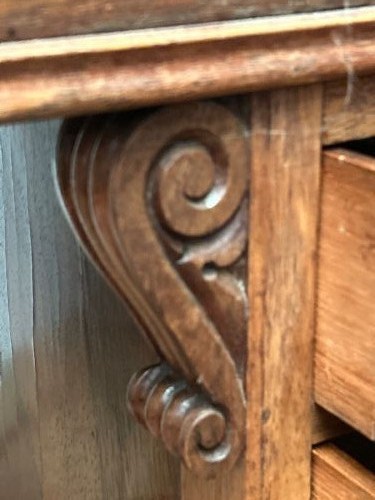 A Regency rosewood Davenport desk featuring an inclined leather-inlaid writing slope, a spindle top rail, side drawers, and turned front columns. View IX
