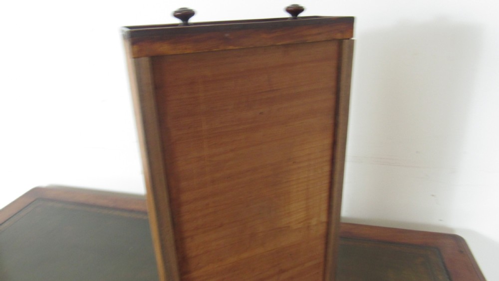 A dark mahogany pedestal desk featuring an inset leather writing surface, multiple drawers fitted with turned wooden knobs, and a central kneehole. View VIII