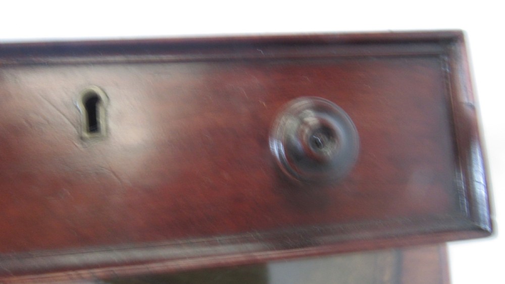 A dark mahogany pedestal desk featuring an inset leather writing surface, multiple drawers fitted with turned wooden knobs, and a central kneehole. View IX