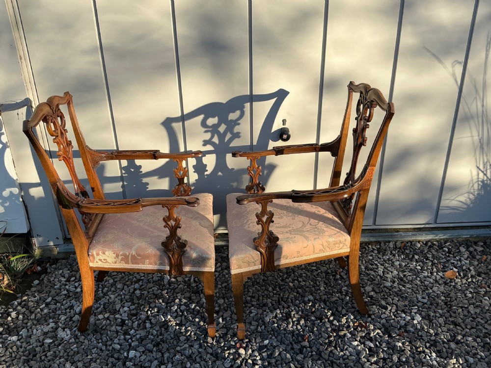 A set of eight mahogany Chippendale style dining chairs featuring elaborate pierced back splats and patterned upholstered seats. View IV