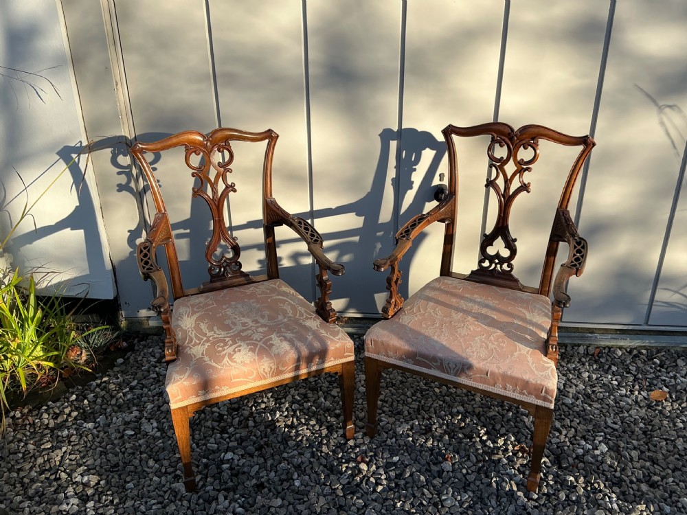 A set of eight mahogany Chippendale style dining chairs featuring elaborate pierced back splats and patterned upholstered seats. View V