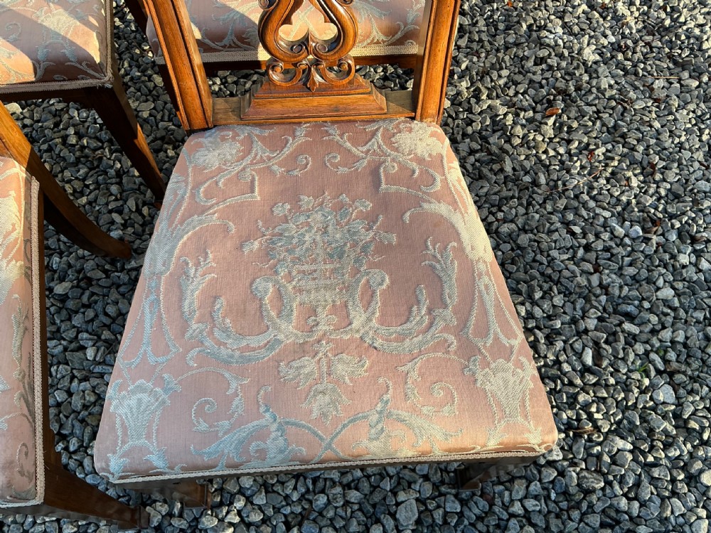 A set of eight mahogany Chippendale style dining chairs featuring elaborate pierced back splats and patterned upholstered seats. View XV