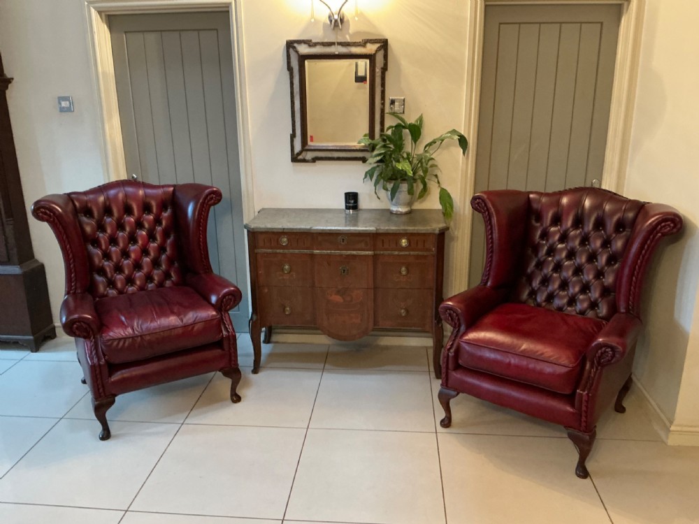 Superb pair of red leather wing arm chairs