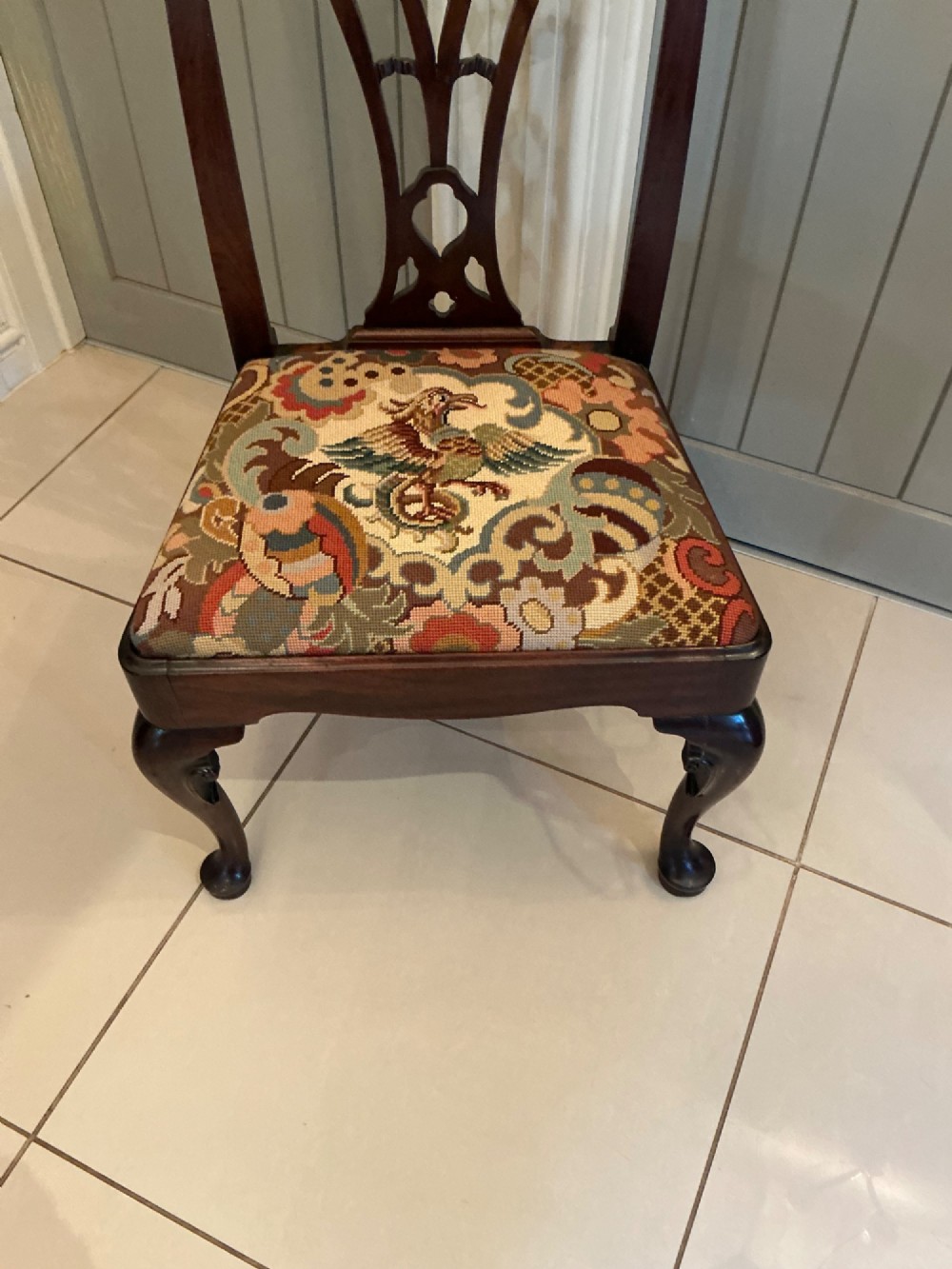 A Georgian mahogany side chair featuring a carved pierced splat back, cabriole front legs, and a needlepoint drop-in seat with a bird pattern. View III