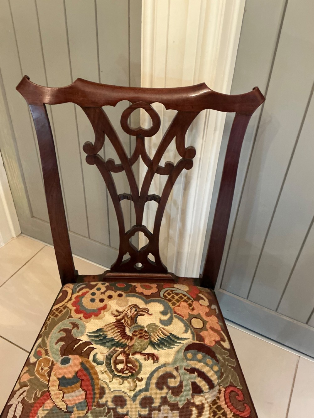 A Georgian mahogany side chair featuring a carved pierced splat back, cabriole front legs, and a needlepoint drop-in seat with a bird pattern. View IV