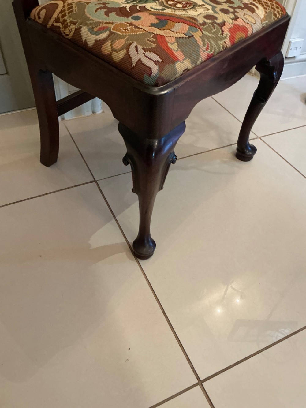 A Georgian mahogany side chair featuring a carved pierced splat back, cabriole front legs, and a needlepoint drop-in seat with a bird pattern. View V