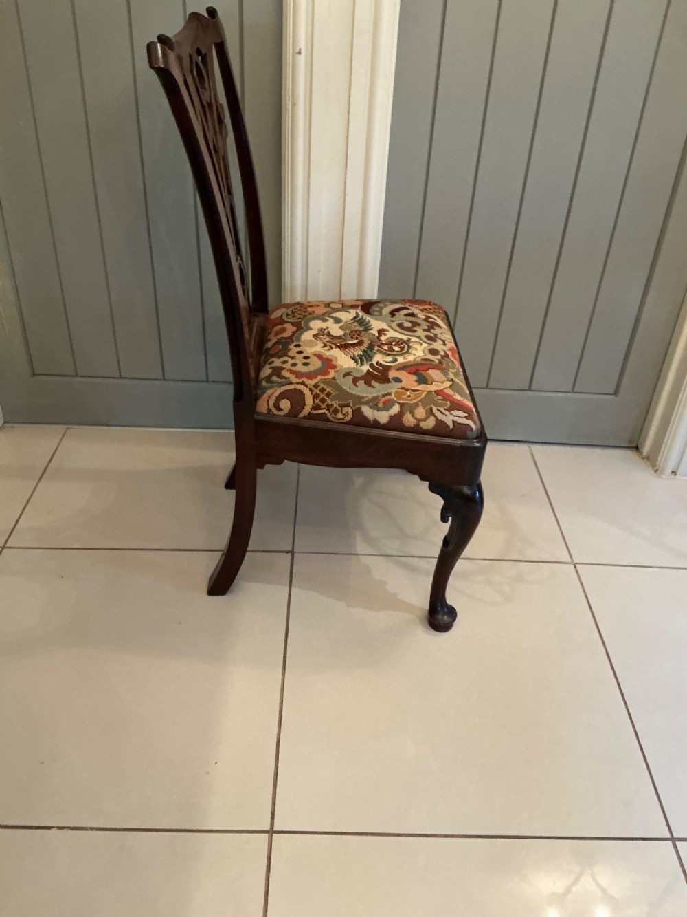A Georgian mahogany side chair featuring a carved pierced splat back, cabriole front legs, and a needlepoint drop-in seat with a bird pattern. View VIII