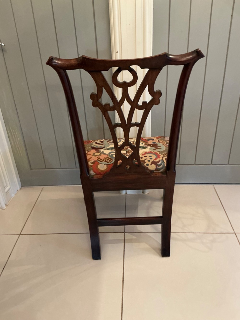 A Georgian mahogany side chair featuring a carved pierced splat back, cabriole front legs, and a needlepoint drop-in seat with a bird pattern. View XIII