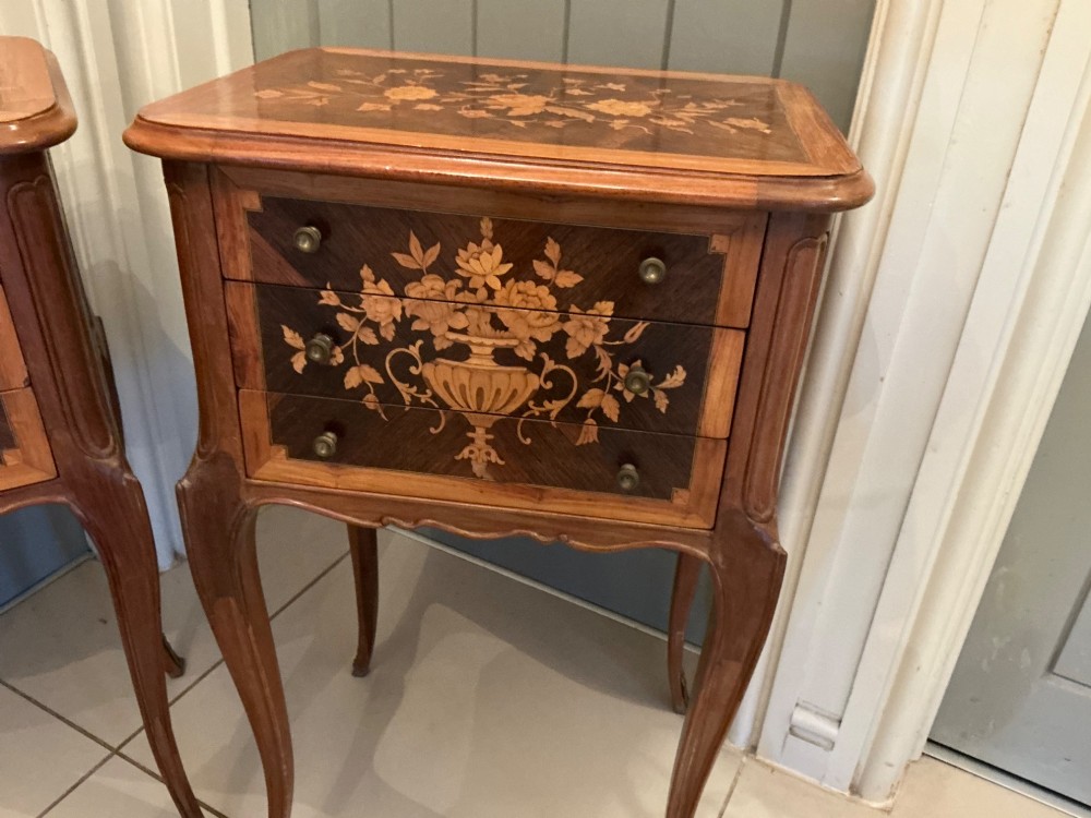 A pair of French Louis XV style wooden bedside tables decorated with intricate floral marquetry inlays and supported by cabriole legs with metal sabots. View III