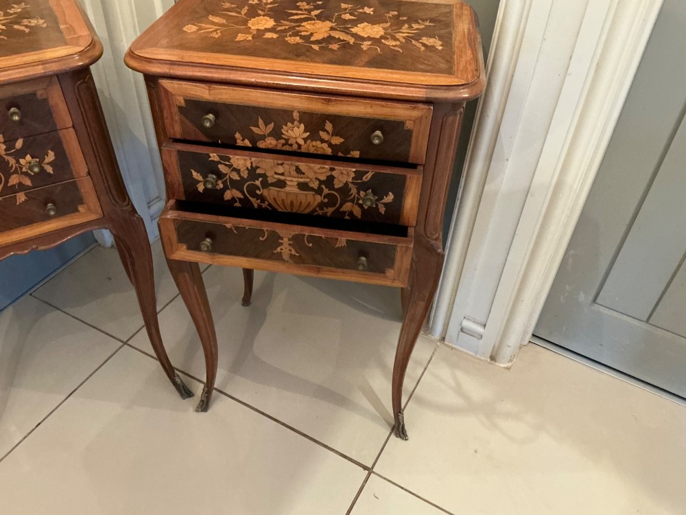 A pair of French Louis XV style wooden bedside tables decorated with intricate floral marquetry inlays and supported by cabriole legs with metal sabots. View VII