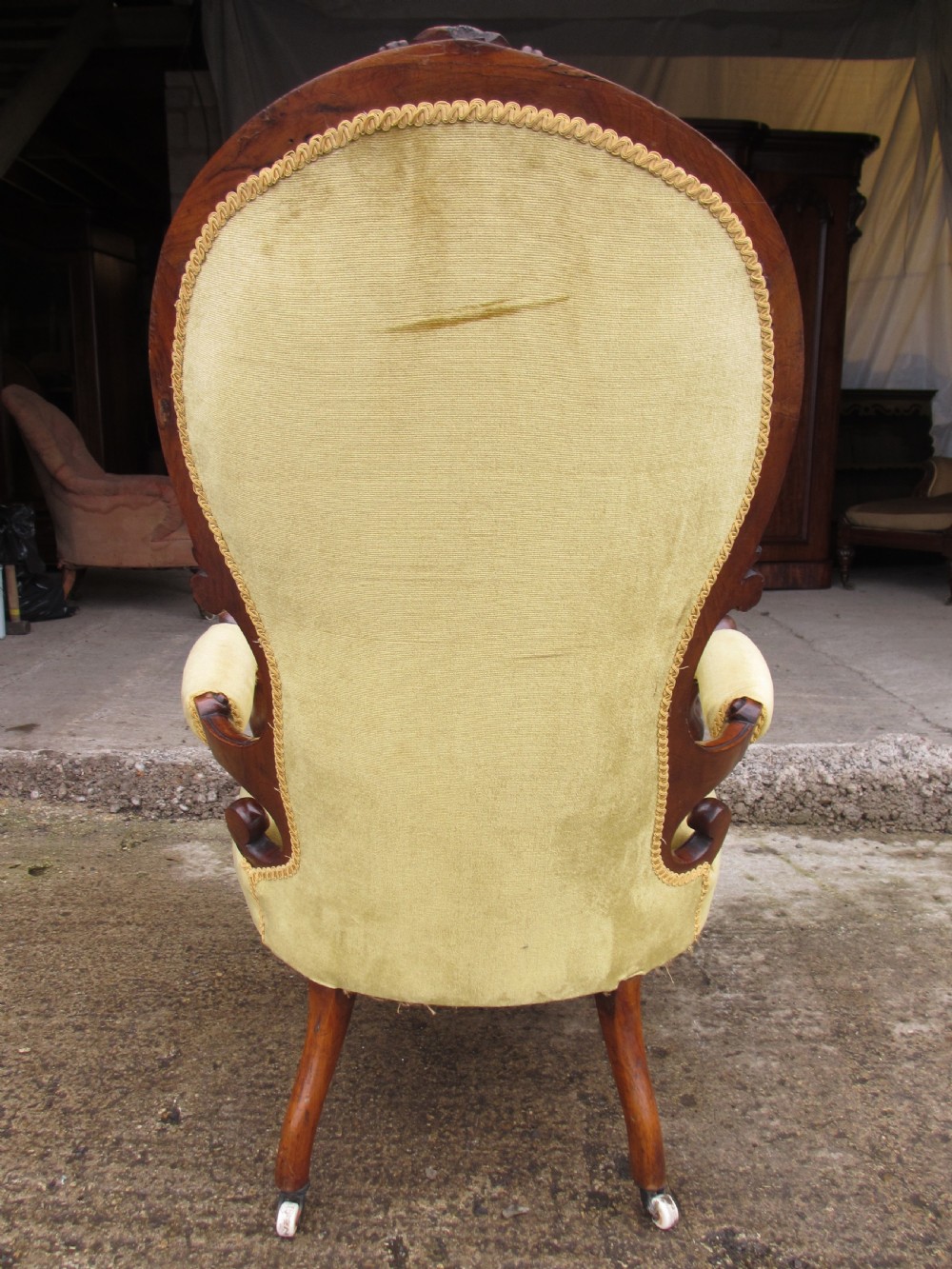 A Victorian walnut open armchair featuring a curved spoon back with button-tufted yellow velvet upholstery and carved cabriole legs. View XIII
