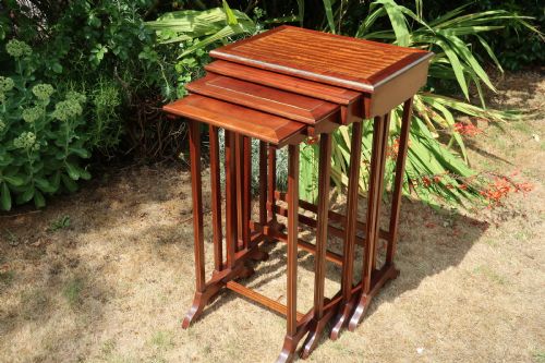 A Nest of Four Brass Inlaid Mahogany Tables