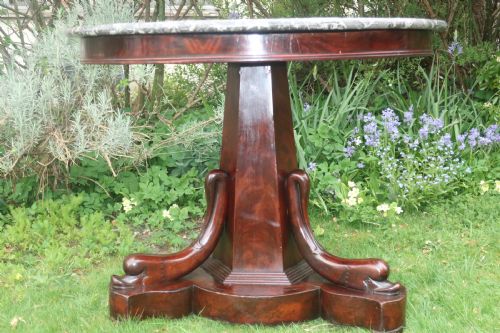 Flame Mahogany Gueridon with Dolphin Decoration.