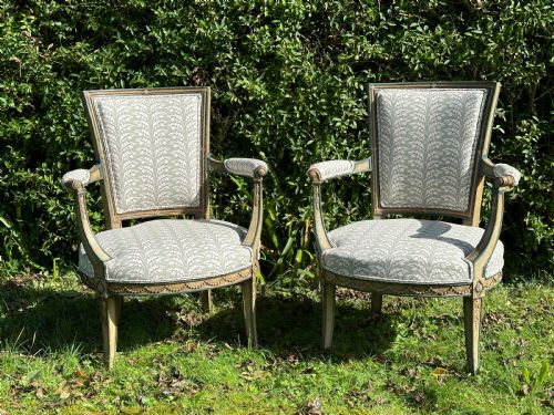 A Pair of French Neoclassical Open Armchairs