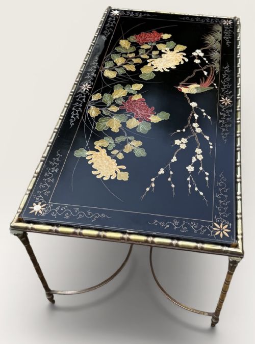 A rectangular mid-century low table featuring a faux-bamboo brass frame, X-form stretchers, and a black lacquered top decorated with colourful Chinoiserie floral patterns. View VII