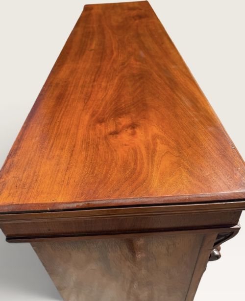 A 19th-century Victorian open walnut bookcase featuring four tiers, decorative carved corbels beneath a moulded top cornice, and a solid plinth base. View V