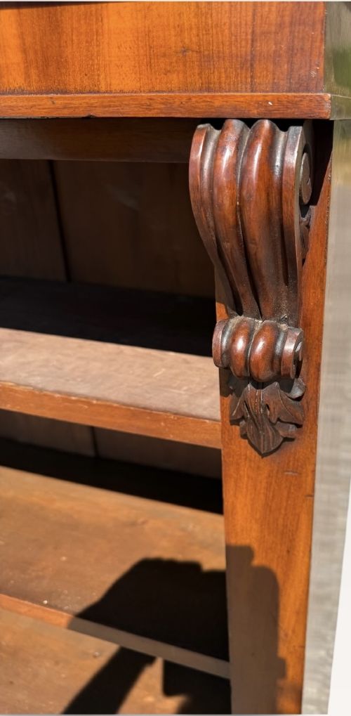 A 19th-century Victorian open walnut bookcase featuring four tiers, decorative carved corbels beneath a moulded top cornice, and a solid plinth base. View VI