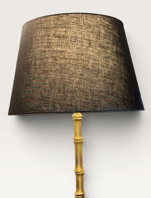 A tall brass floor lamp featuring a faux bamboo stem on a curved tripod base, topped with a cylindrical black woven fabric lampshade. View II