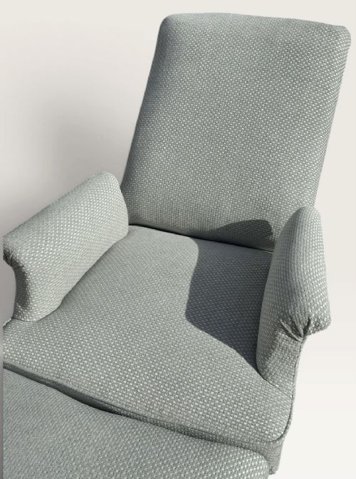 A 19th-century French reclining armchair and matching contoured footstool upholstered in pale blue woven fabric with dark turned wood legs on brass castors. View III