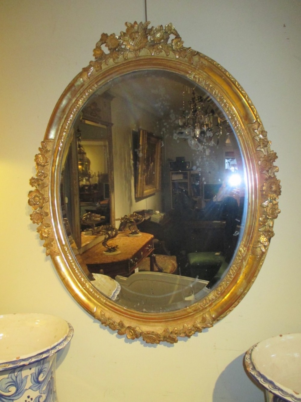 Large oval carved gilt wood mirror
