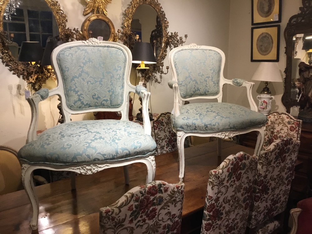A pair of pretty French open armchairs 