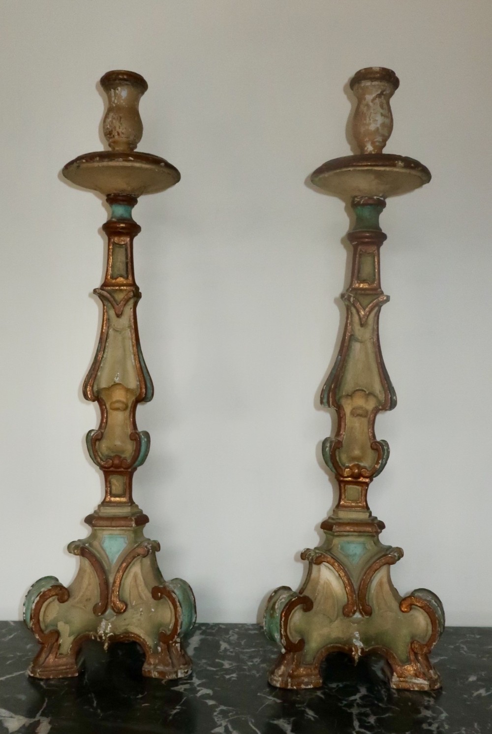 A large pair of original painted candlesticks 