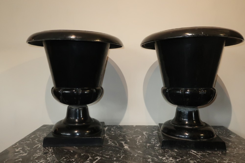 Pair of black enamelled garden urns 