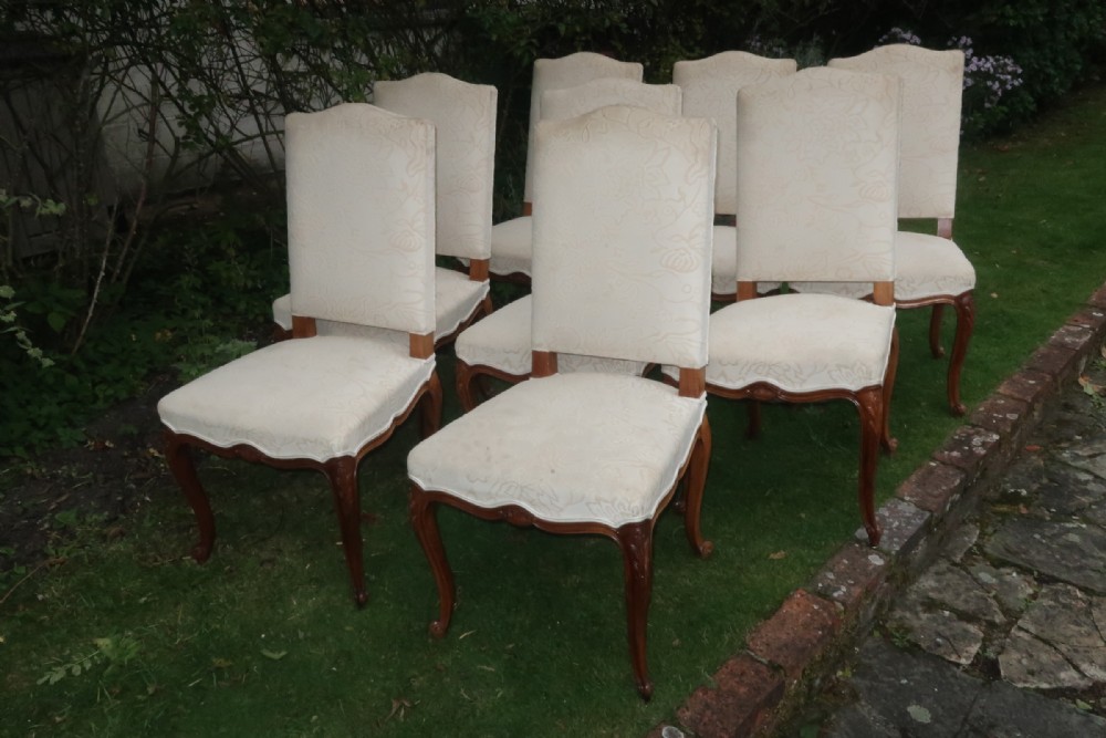 Set of eight carved walnut French armchairs. 