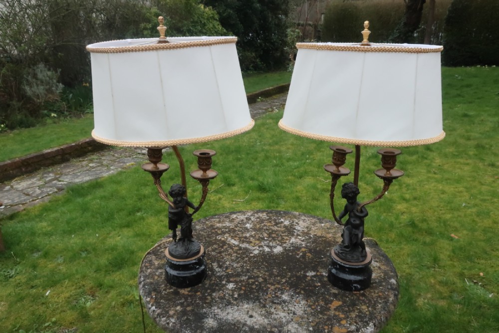 Pair of bronze cherub lamps 