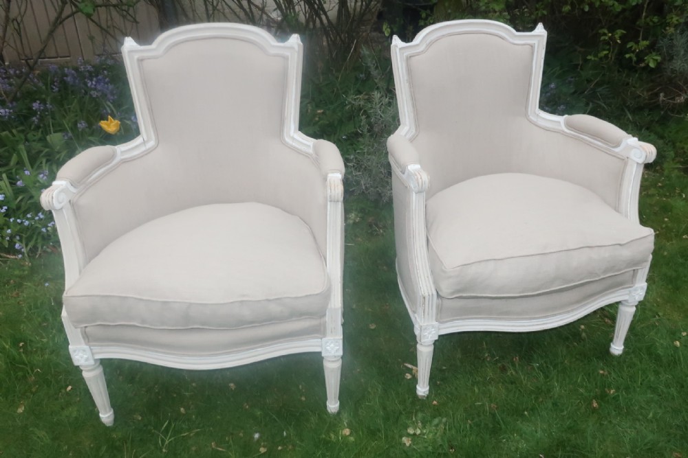 A pair of French upholstered armchairs 