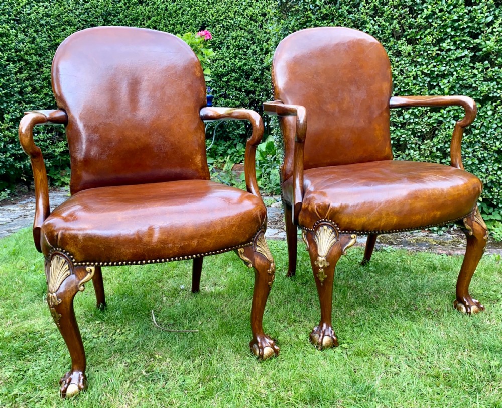 A pair of leather and gilt armchairs 