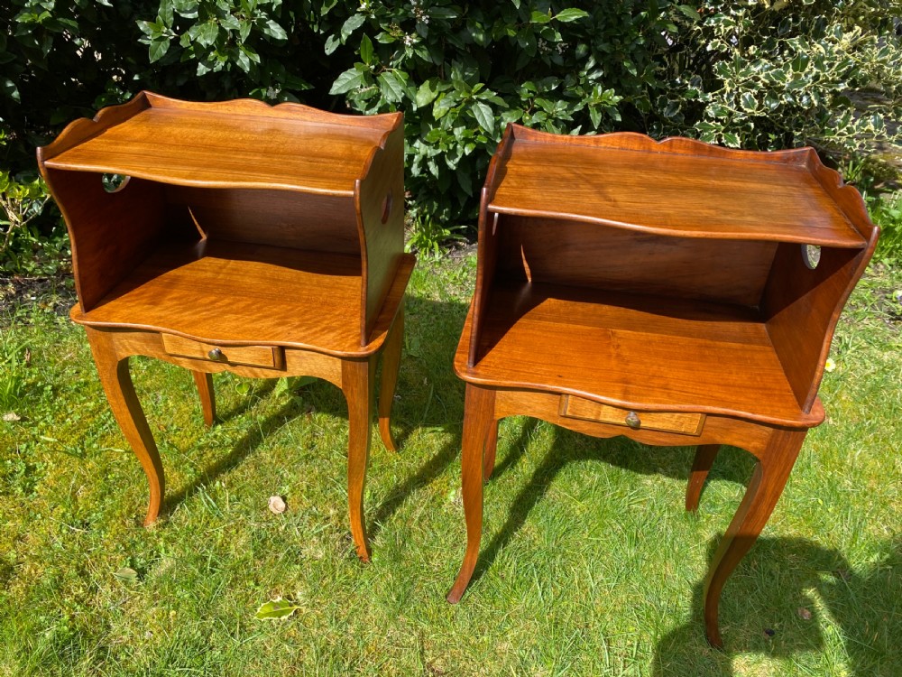 A pair of walnut bedside tables 