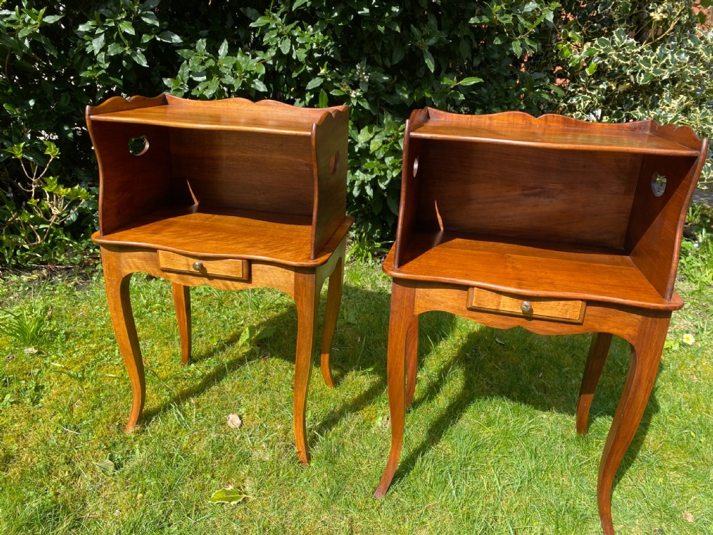A pair of walnut bedside tables  View II