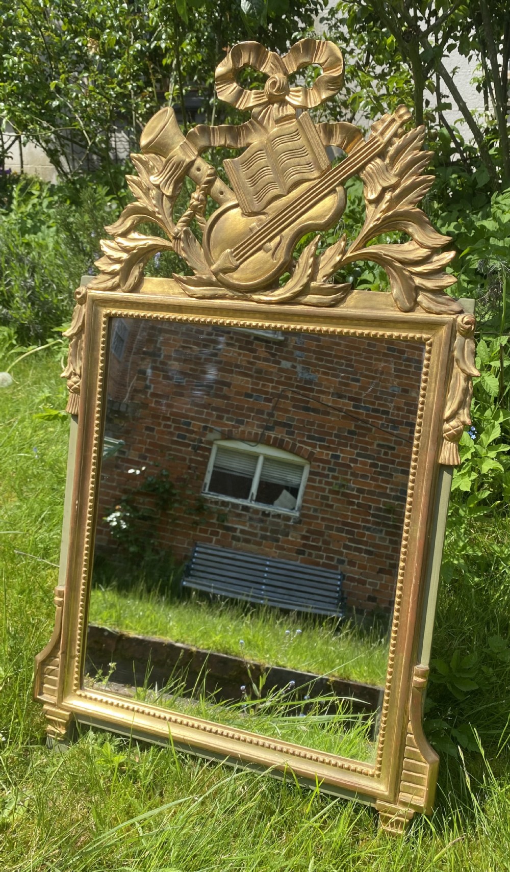 Small gilt mirror with musical motifs