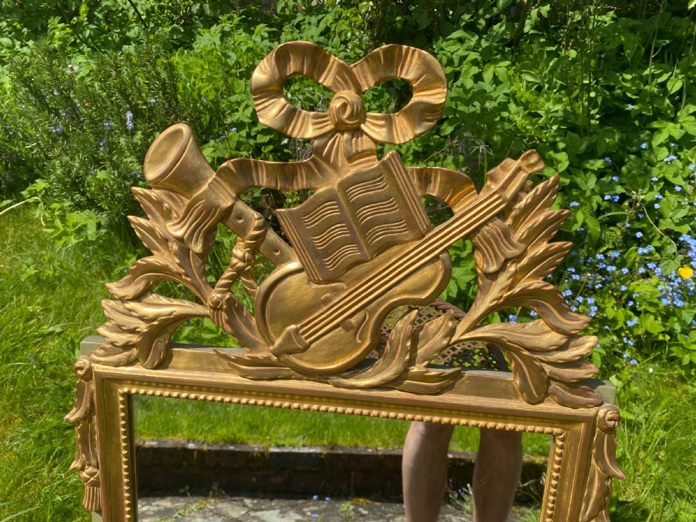Small gilt mirror with musical motifs View V