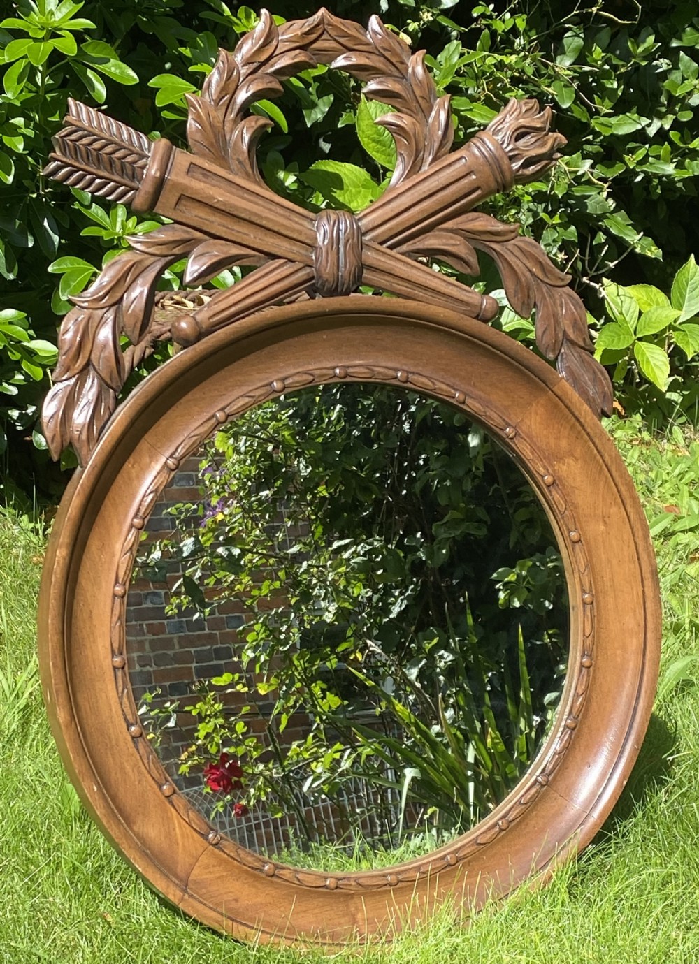 Round walnut mirror with crest