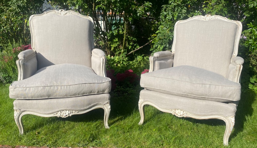 A Pair of newly upholstered French Bergere armchairs in grey linen