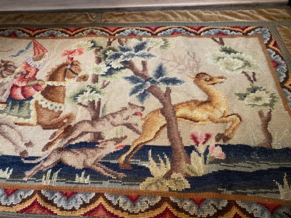 A rectangular early French needlepoint panel featuring a hunting scene with figures on horseback, hounds, and a stag within a velvet border. View III