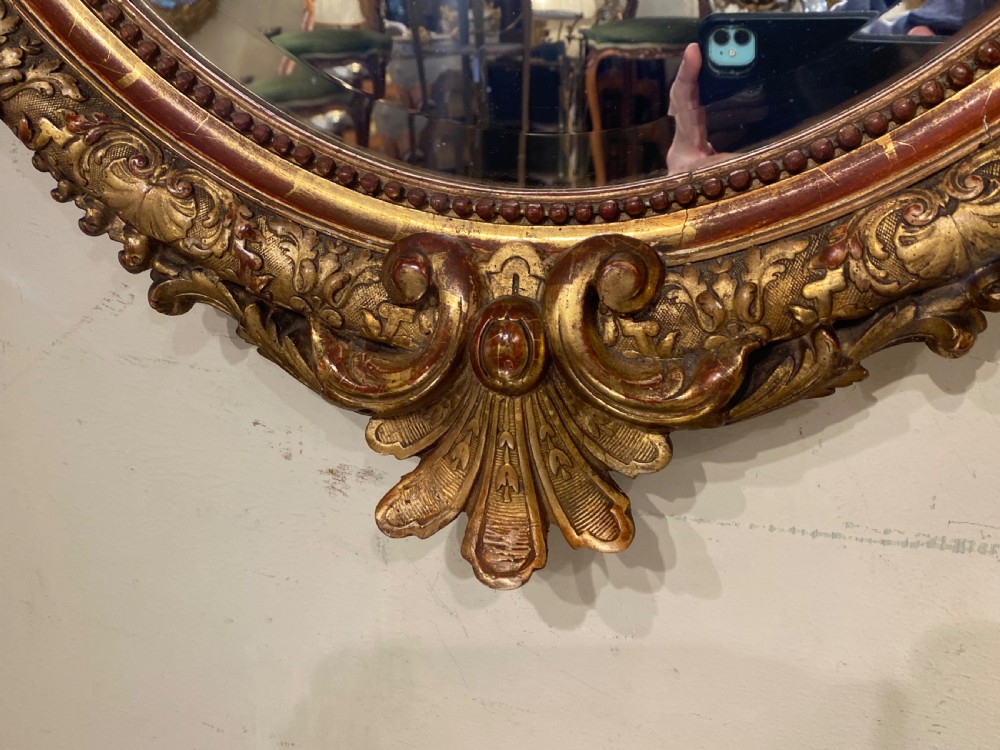 Large 19th Century oval gilt mirror  View III